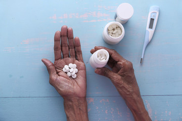 top view of pills on palm of senior women hand 