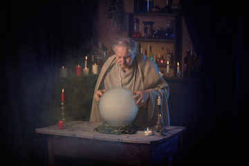 elderly wizard  with crystal ball
