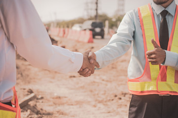 Fototapeta premium Businessman two people shake hand success at construction site partnership community