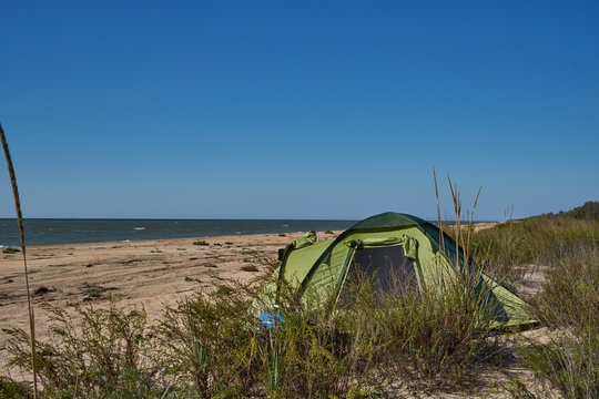 Image of a tent on a sandy beach.