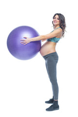 Fototapeta premium Portrait of a beautiful young pregnant woman exercises with fitball. Working out and fitness, pregnancy concept. Isolated white background.