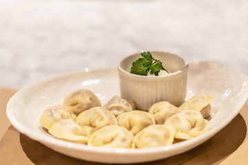 Ural dumplings on a white plate. Traditional Russian cuisine