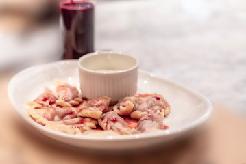 Vareniki with a cherry on a white plate. Traditional Russian cuisine.