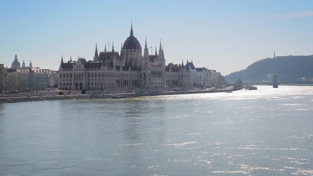 Center of Budapest with Hungarian Parliament and Szechenyi Chain Bridge over the Danube river. Sunny winter day, slow motion