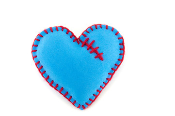 Handmade blue stitched toy heart on white