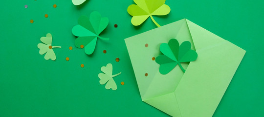 St. Patrick's day, clover on a green shiny background