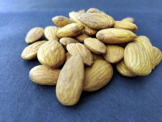 some fresh healthy almonds put on black background