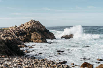 waves cresting over rock