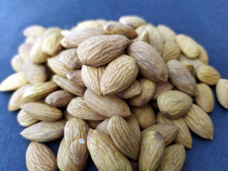 some fresh healthy almonds put on black background