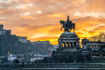 Colorful Sunrise burning sky Koblenz City historic monument German Corner where river rhine and mosele flow together - obrazy, fototapety, plakaty