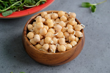 Sprouts or seedlings of chickpea beans in a bowl, close up. Vegan diet and healthy eating.