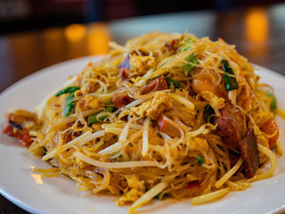 Close up shot of a plate of delicious Singapore curry noodles