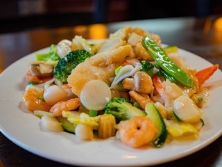 Close up shot of a plate of fried seafood and vegatable