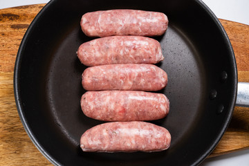 raw sausages fried in pan semi-finished view top