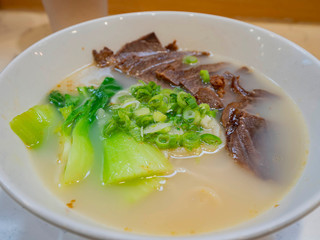 Close up shot of a bowl of delicious beef hand pulled noodle
