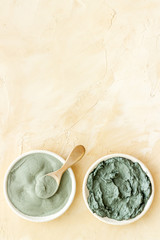 Blue cosmetic clay on beige background top-down copy space