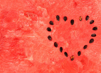 Red ripe sweet watermelon with heart from out of seeds