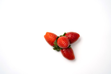Red and fresh strawberries isolated on white