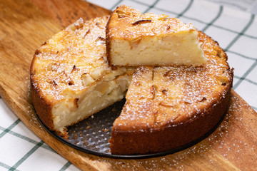 cut off part homemade cake pan on wooden Board. 