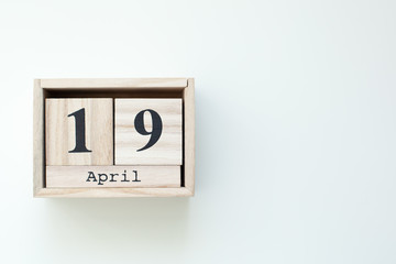 April 19 Easter Wooden block calendar on white isolated background. Easter. View from above with...