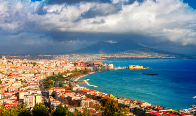 Fototapeta na wymiar Panoramic scenic view of Naples after rain, Campania, Italy. Part of the rainbow is visible.