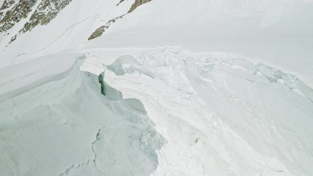 Huge collapsed hollow in deep thick snow, avalanche danger at mountains