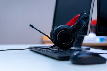 Obraz na płótnie Canvas close up gamer's headset on keyboard desktop computer PC for Esport championship tournament concept