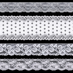 Set of white delicate tape lace on a black background. Vintage style.