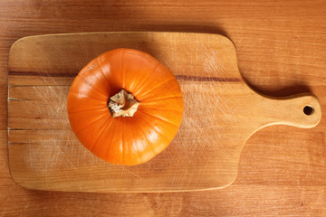 Pumpkin on wooden board. Directly Above.