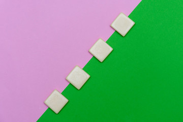 Green and pink background with four blank word tile blocks for concept of growth, goal setting, progress and achievement in business or education.