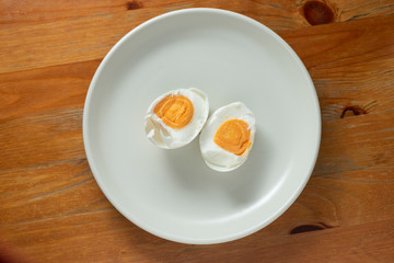 Salted eggs in a white plate.