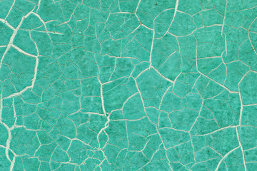 Old abandoned wall with peeling cracked green paint. Abstract trendy modern texture background