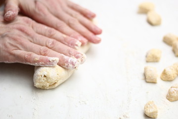 Gnocchi being prepared. Rolling up dough.