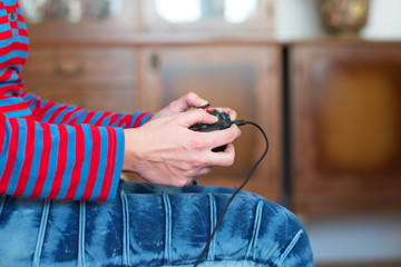 Midsectiom of young woman playing video games