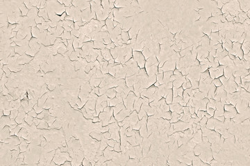 Peeling old cracked beige paint on a concrete wall surface. Modern trendy abstract texture background