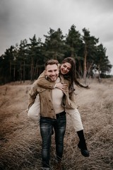 Love story of Oleg and Anastasia. Stylish photo shoot in the forest in cloudy weather.
