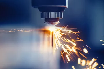Zelfklevend Fotobehang CNC gas cutting metal sheet, sparks fly. Blue steel color, modern industrial technology © Parilov