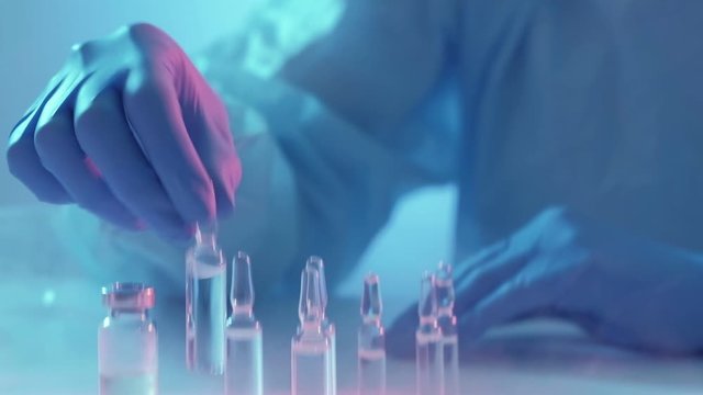 Vaccination covid-19. Clinical study. Female technician testing immunogen in lab.