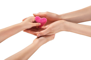  Children’s hands give a pink heart to their mother’s hands.