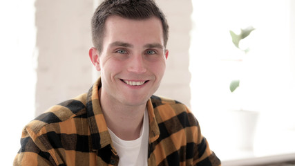 The Smiling Casual Young Man Looking at Camera