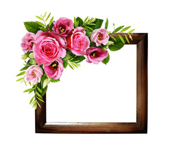 Pink roses and eustoma flowers in a floral corner arrangement on wodden frame