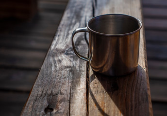 metallic cup on a wooden table