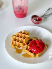Fresh belgian waffles with berry ice cream in a white plate