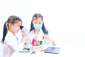 Kids doctor making experiment for learning about Anti Covid-19 measures. Children dream job...