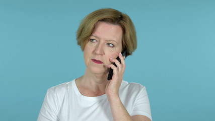 The Old Woman Talking on Smartphone Isolated on Blue Background