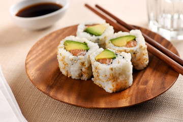 Four traditional uramaki sushi on circular tray