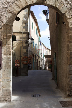 Scansano (GR), Italy - June 10, 2017: A central road and typical houses in Scansano, Grosseto, Tuscany, Italy