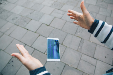 hands holding phone with broken cracked screen