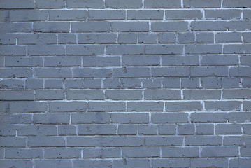 old brick wall with a thick layer of paint