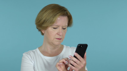 The Old Woman Browsing Smartphone Isolated on Blue Background